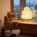 Nerine Tiered Washi Paper Table Lamp | Washi Paper and Metal | Set on a cozy window seat overlooking a city skyline | Severn Lighting
