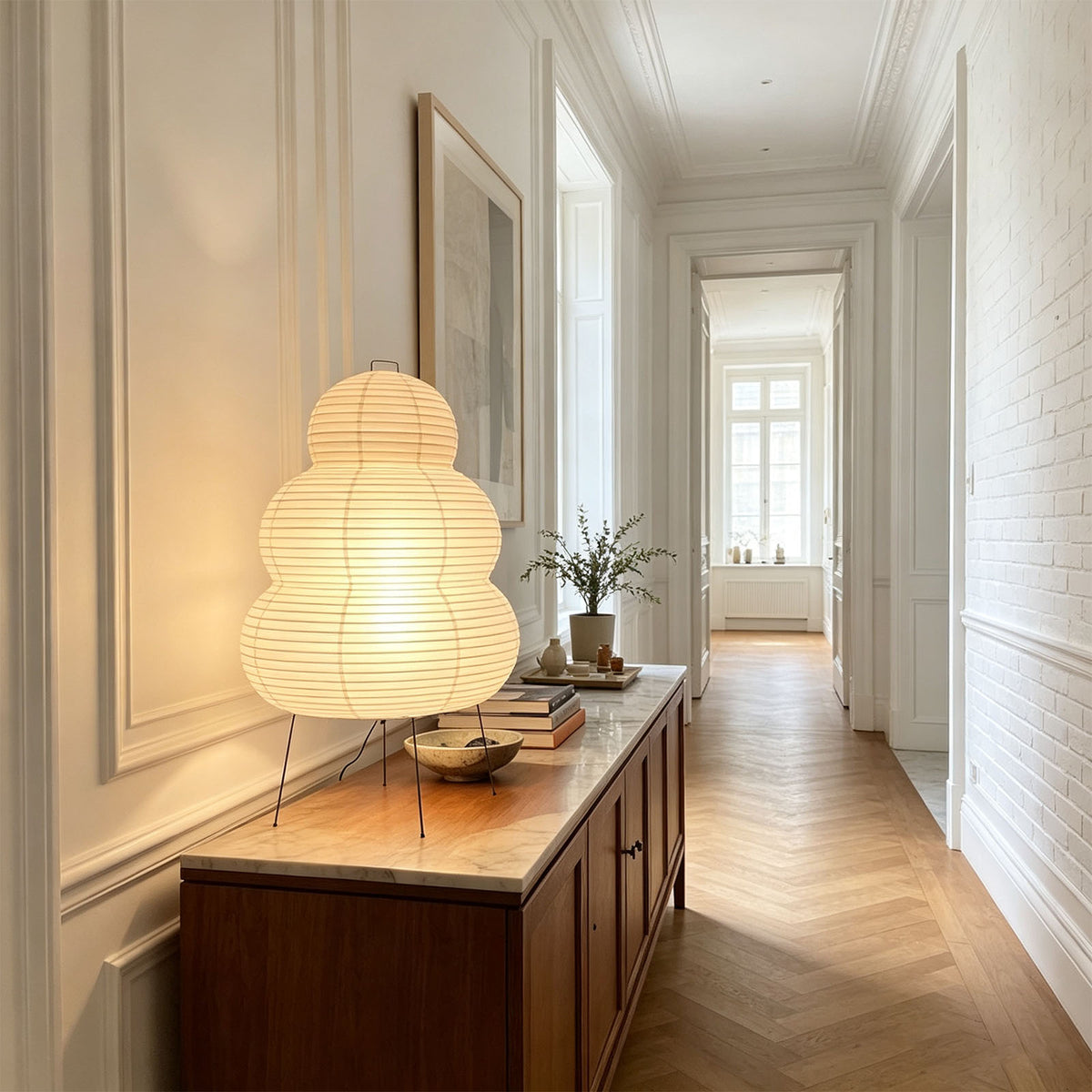 Nerine Tiered Washi Paper Table Lamp | Washi Paper and Metal | Positioned on a wooden console table in a bright hallway | Severn Lighting