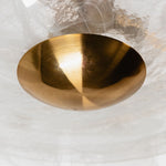 Nyle Tiered Glass Ring Chandelier | Textured Glass and Brass | Close-up shot of the central brass bottom finial and glass shade | Severn Lighting