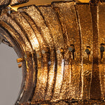 Octavia Sculptural Smoked Glass Chandelier | Textured Smoked Glass | Macro detail of the warm amber light filtering through overlapping textured glass tiers | Severn Lighting