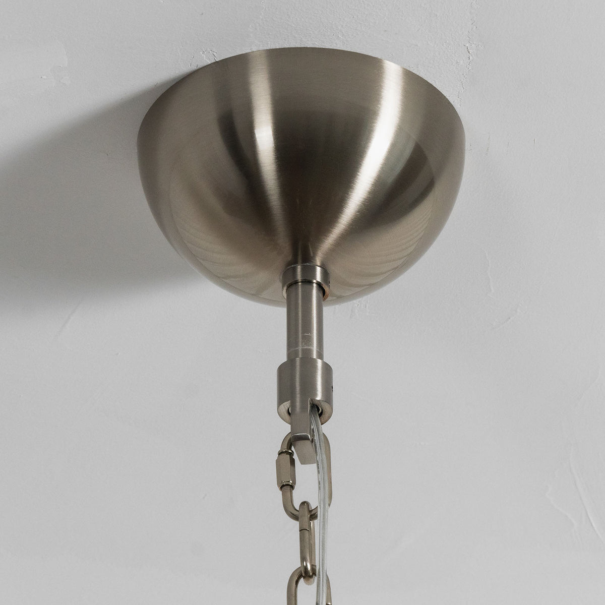 Odile Amber Petal Tier Chandelier | Amber Glass and Metal | Close-up of the brushed metallic canopy ceiling plate and hanging chain | Severn Lighting