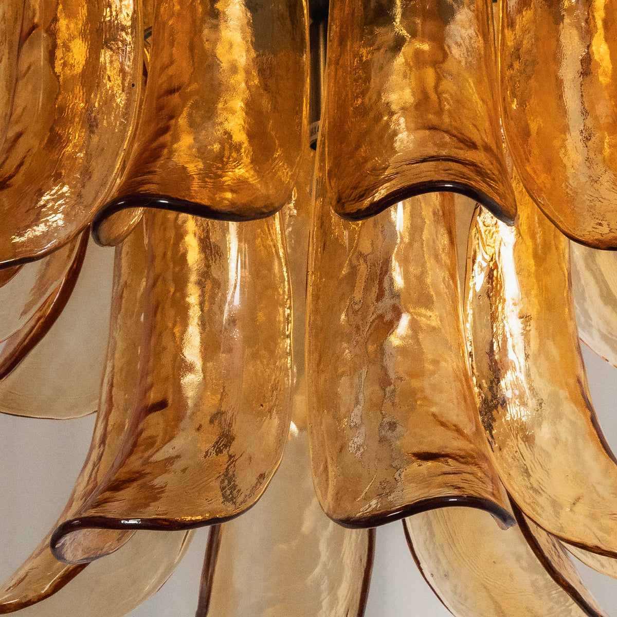 Odile Amber Petal Tier Chandelier | Amber Glass and Metal | Detail shot highlighting the curved tips of the amber glass petals | Severn Lighting