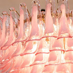 Ombeline Tiered Pink Glass Chandelier | Pink Glass and Brass | Close-up view of the glowing tiered pink glass petal elements | Severn Lighting