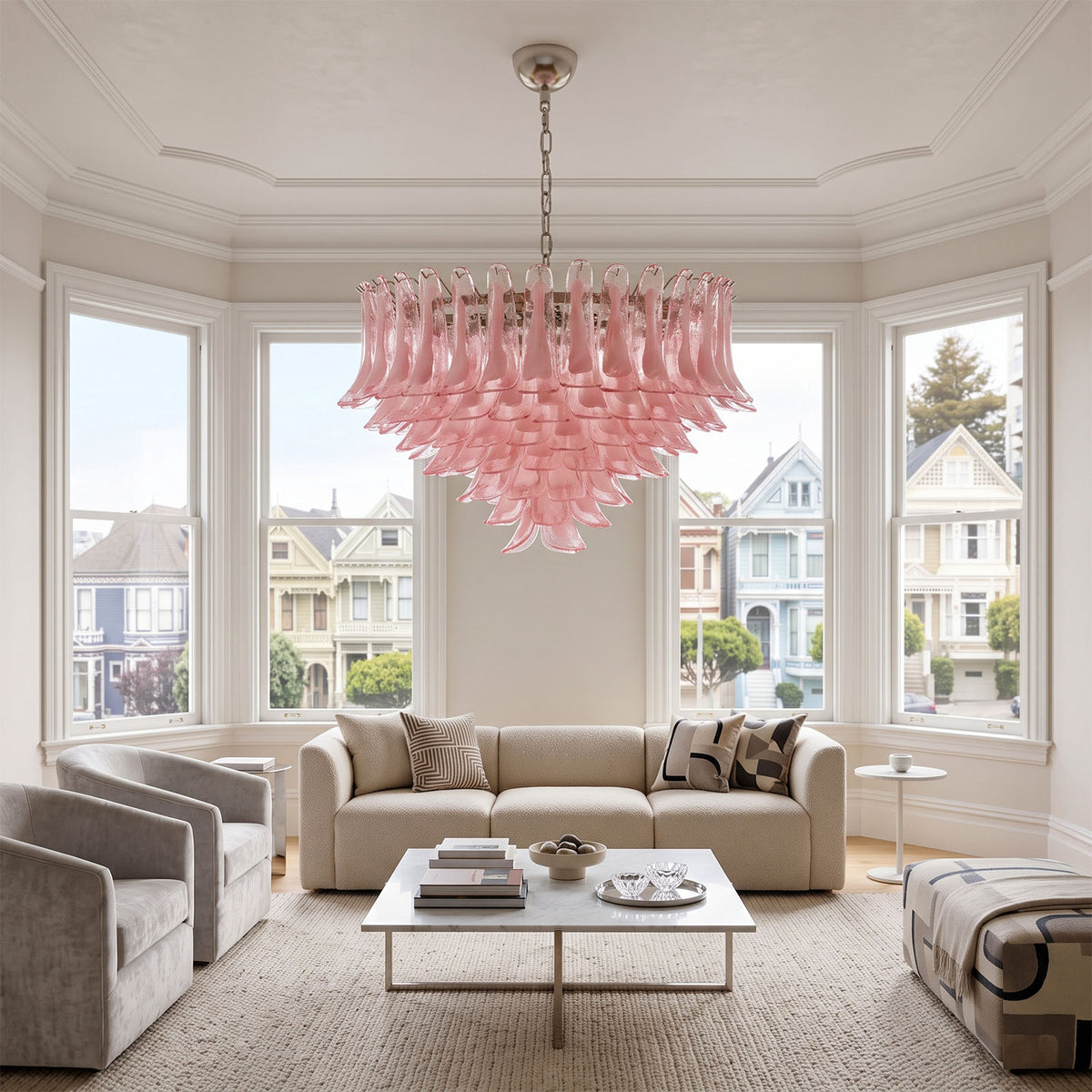 Ombeline Tiered Pink Glass Chandelier | Pink Glass and Brass | Centered above a coffee table in a bright living room with white sofa | Severn Lighting