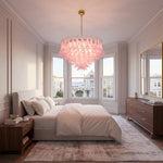 Ombeline Tiered Pink Glass Chandelier | Pink Glass and Brass | Displayed in a luxury bedroom with plush bed and large windows | Severn Lighting