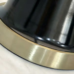 Orsino Alabaster Trapezoid Table Lamp | Natural Alabaster, Black Metal and Brass | Macro detail highlighting the glossy black base and brushed brass bottom ring | Severn Lighting