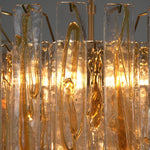 Orvelane Amber Swirl Glass Tiered Chandelier | Amber Swirl Glass and Brass | Macro detail shot highlighting warm light glowing through amber swirl glass | Severn Lighting