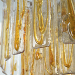 Orvelane Amber Swirl Glass Tiered Chandelier | Amber Swirl Glass and Brass | Macro close-up shot of translucent glass panels with golden amber swirls | Severn Lighting