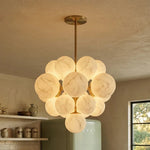 Ottoline Alabaster Cluster Chandelier | Natural Alabaster and Brass | Casting a warm ambient glow in a kitchen corner next to a vintage green refrigerator | Severn Lighting