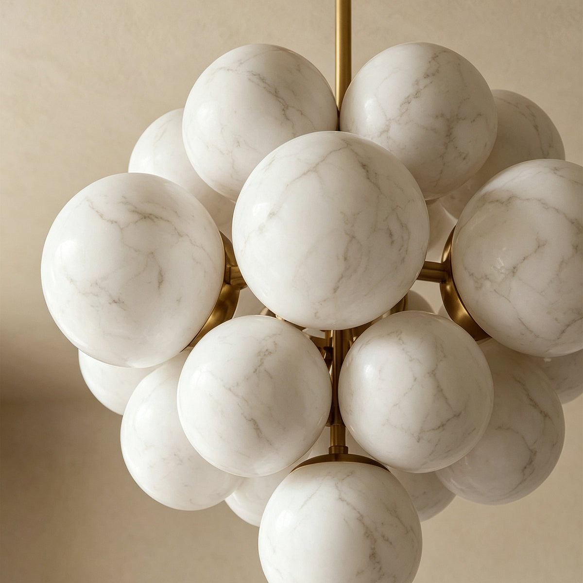 Ottoline Alabaster Cluster Chandelier | Natural Alabaster and Brass | Close-up view of the unlit cluster of white stone spheres showcasing their organic stone patterns | Severn Lighting