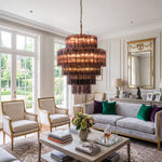 Ottoline Tiered Glass Chandelier | Textured Glass and Brass | Hanging in an elegant living room with a grey sofa | Severn Lighting