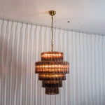 Ottoline Tiered Glass Chandelier | Textured Glass and Brass | Full hanging view displayed elegantly against white sheer curtains | Severn Lighting