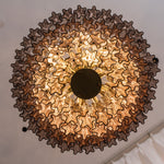 Ottoline Tiered Glass Chandelier | Textured Glass and Brass | Bottom-up perspective revealing the radial symmetry and warm bulbs | Severn Lighting