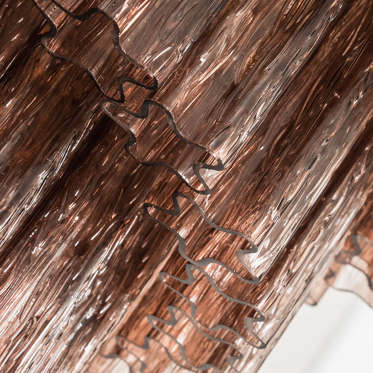 Ottoline Tiered Glass Chandelier | Textured Glass and Brass | Detail shot focusing on the textured surface of the glass rods | Severn Lighting