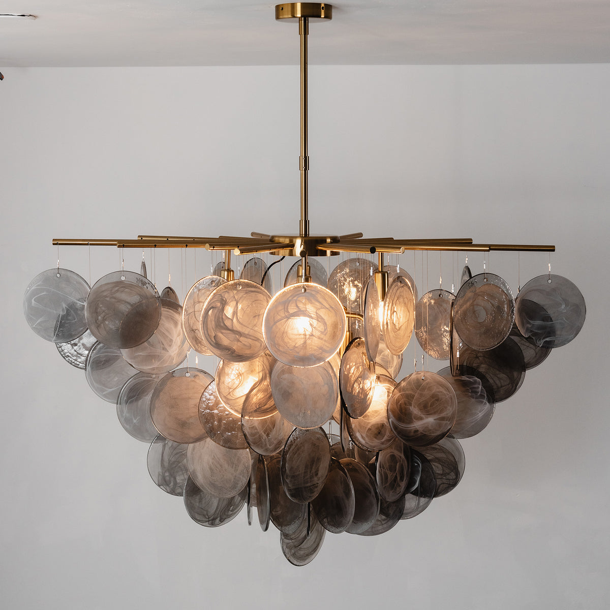Perrin Smoked Glass Cloud Chandelier | Smoked Glass and Brass | Front illuminated view displayed in a modern studio setting | Severn Lighting