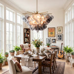 Perrin Smoked Glass Cloud Chandelier | Smoked Glass and Brass | Hanging in a bright dining room with large windows and indoor plants | Severn Lighting