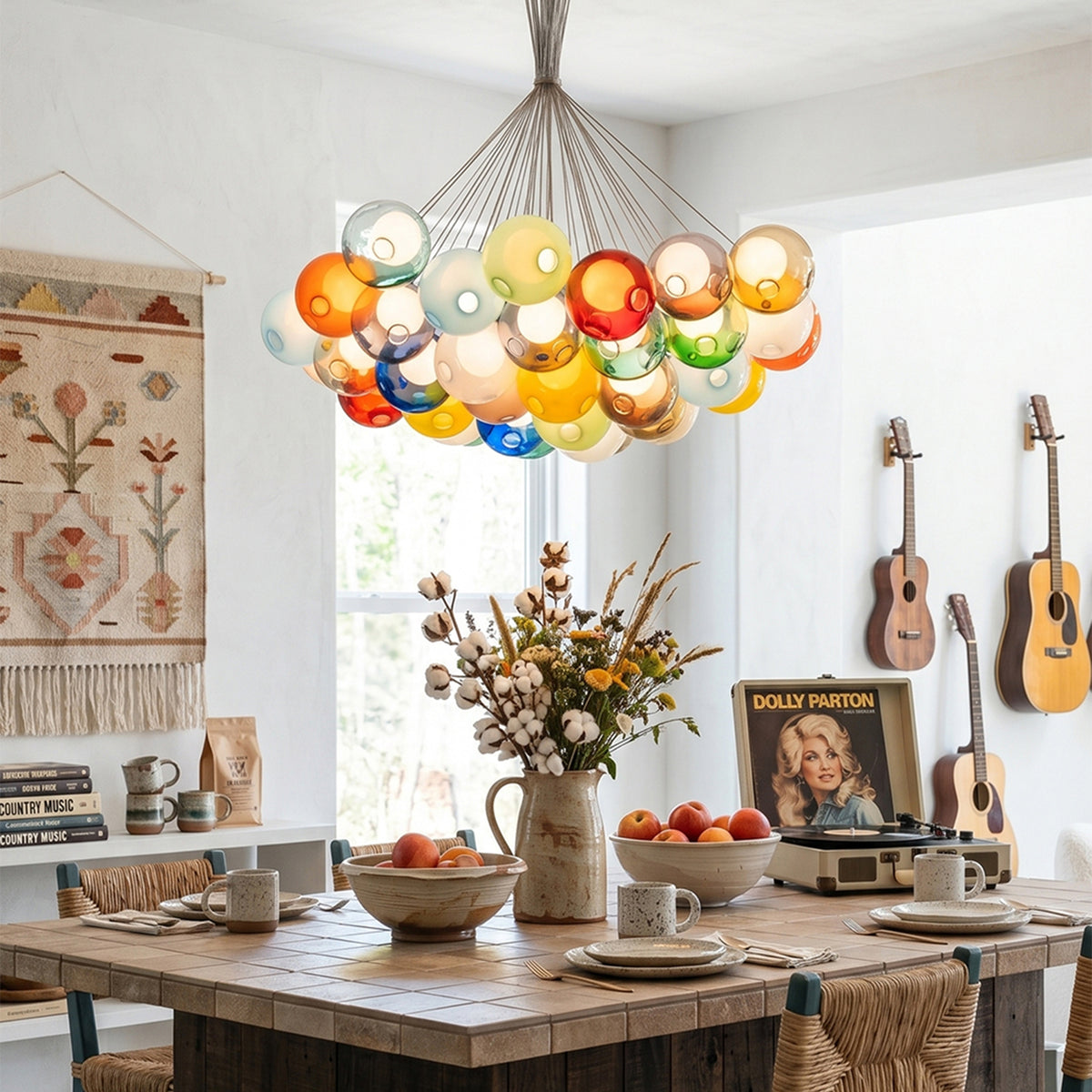 Rainbow Glass Bubble Cluster Chandelier | Multi-colored Blown Glass and Metal Cords | Hanging above a long wooden dining table decorated with a large floral arrangement | Severn Lighting