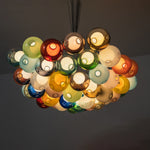 Rainbow Glass Bubble Cluster Chandelier | Multi-colored Blown Glass and Metal Cords | Looking up perspective of the glowing colorful glass cluster fixture against a dark background | Severn Lighting