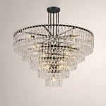 Rainer Cascading Glass Rod Chandelier | Clear Glass and Brass | Brass frame option illuminated on a plain white background | Severn Lighting