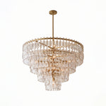 Rainer Cascading Glass Rod Chandelier | Clear Glass and Brass | Brass frame option illuminated on a plain white background | Severn Lighting