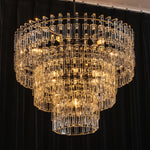 Rainer Cascading Glass Rod Chandelier | Clear Glass and Black Metal | Full view glowing brightly against a dark black backdrop | Severn Lighting