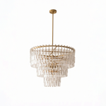 Rainer Cascading Glass Rod Chandelier | Clear Glass and Brass | Brass frame option illuminated on a plain white background | Severn Lighting