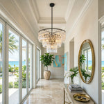 Rainer Cascading Glass Rod Chandelier | Clear Glass and Black Metal | Suspended in an elegant hallway near a round wall mirror | Severn Lighting