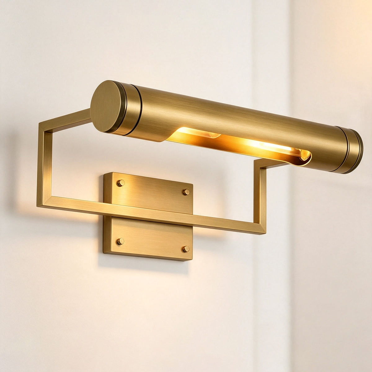 Redmond Brass Picture Wall Lamp | Brass and Metal | Side perspective view of the picture light glowing on a plain white wall | Severn Lighting