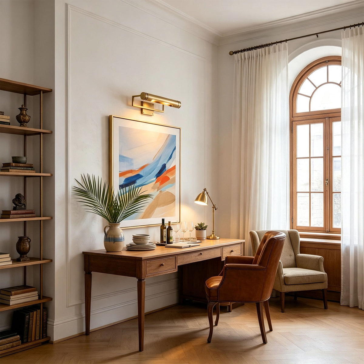 Redmond Brass Picture Wall Lamp | Brass and Metal | Illuminating a colorful wall painting above a wooden study desk | Severn Lighting