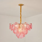 Rosalind Petal Glass Chandelier | Textured Spiral Pink Glass and Gold Metal | Standard product shot of the lit pink tiered fixture hanging from a gold chain on a white wall | Severn Lighting