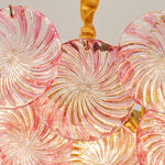 Rosalind Petal Glass Chandelier | Textured Spiral Pink Glass and Gold Metal | Macro view of the lit pink fixture highlighting the internal gold frame and glowing bulbs | Severn Lighting
