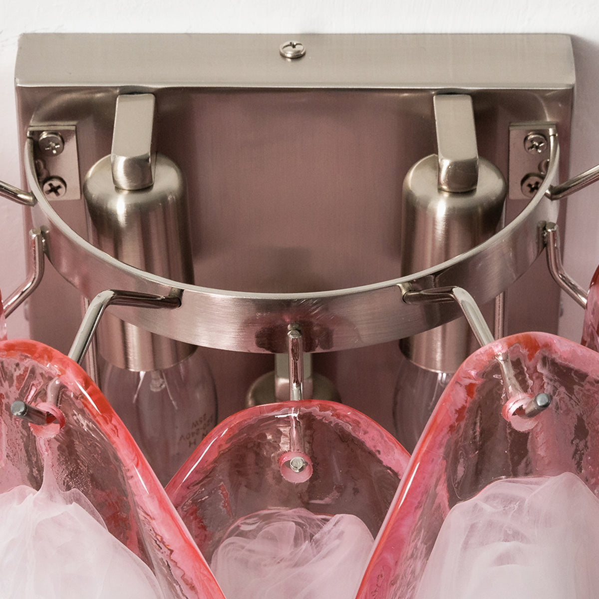 Rosalind Rose Glass Wall Sconce | Glass, Metal | Close-up top-down structural shot showcasing the internal silver chrome metallic frame bracket and dual light bulb sockets | Detail shot | Severn Lighting