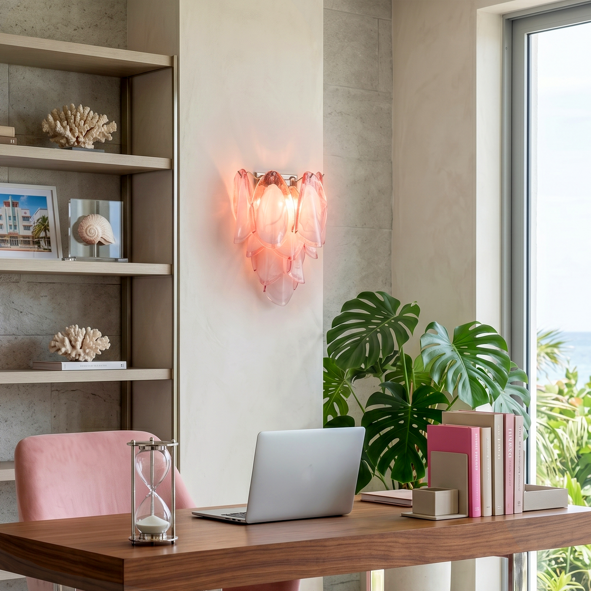 Rosalind Rose Glass Wall Sconce | Glass, Metal | Lit pink glass sconce providing warm romantic accent lighting on a wall in a home office setup with a desk and pink chair | Severn Lighting