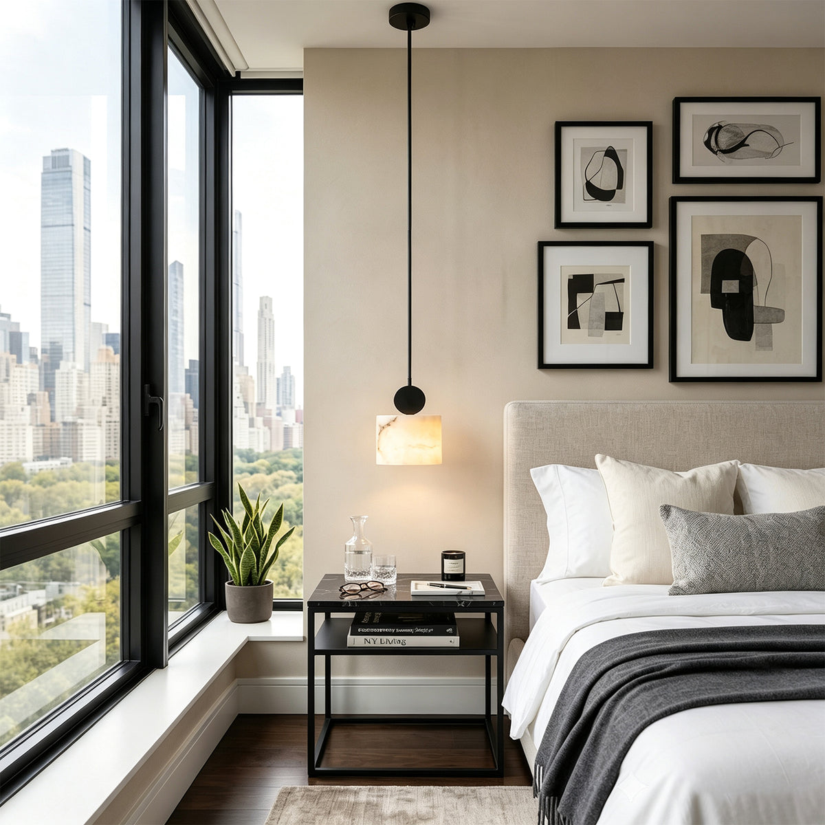 Sabine Alabaster Drum Pendant Light | Natural Alabaster and Brass | Hanging over a black nightstand in a modern bedroom with a large city view window | Severn Lighting