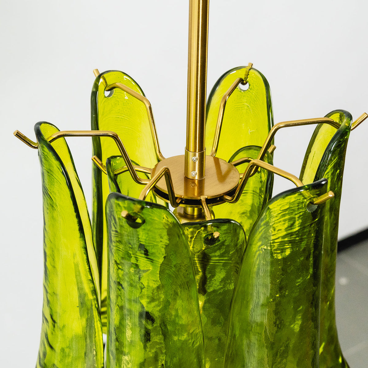 Semoy Curved Glass Petal Pendant Light | Curved Glass and Brass | Angled detail shot of the green curved glass petals flaring outwards | Severn Lighting