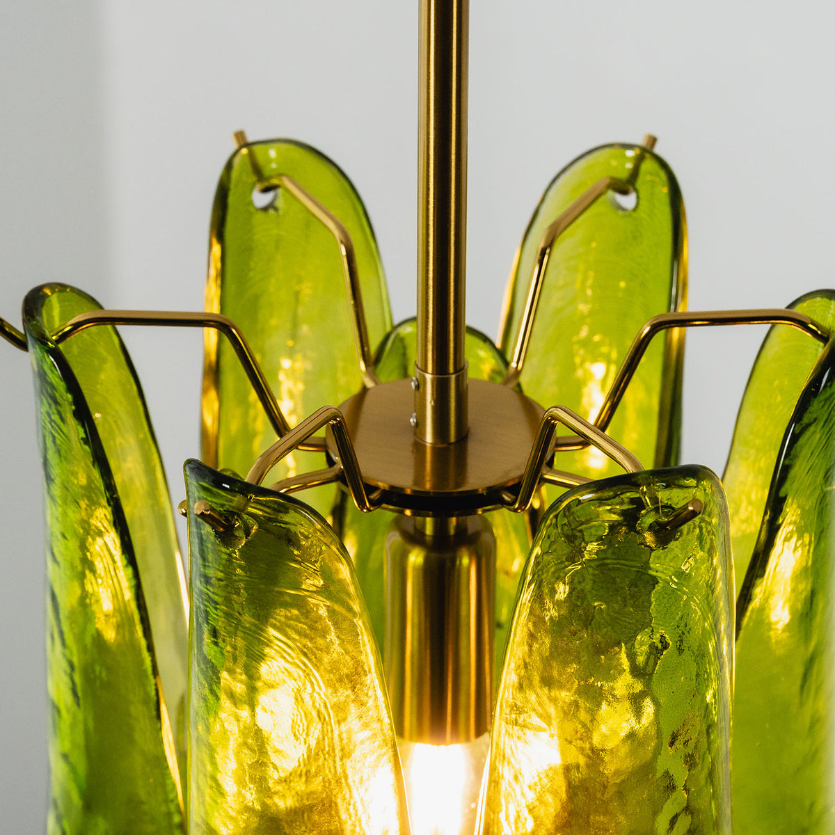 Semoy Curved Glass Petal Pendant Light | Curved Glass and Brass | Top-down angled view showing the brass socket core and green glass petals | Severn Lighting