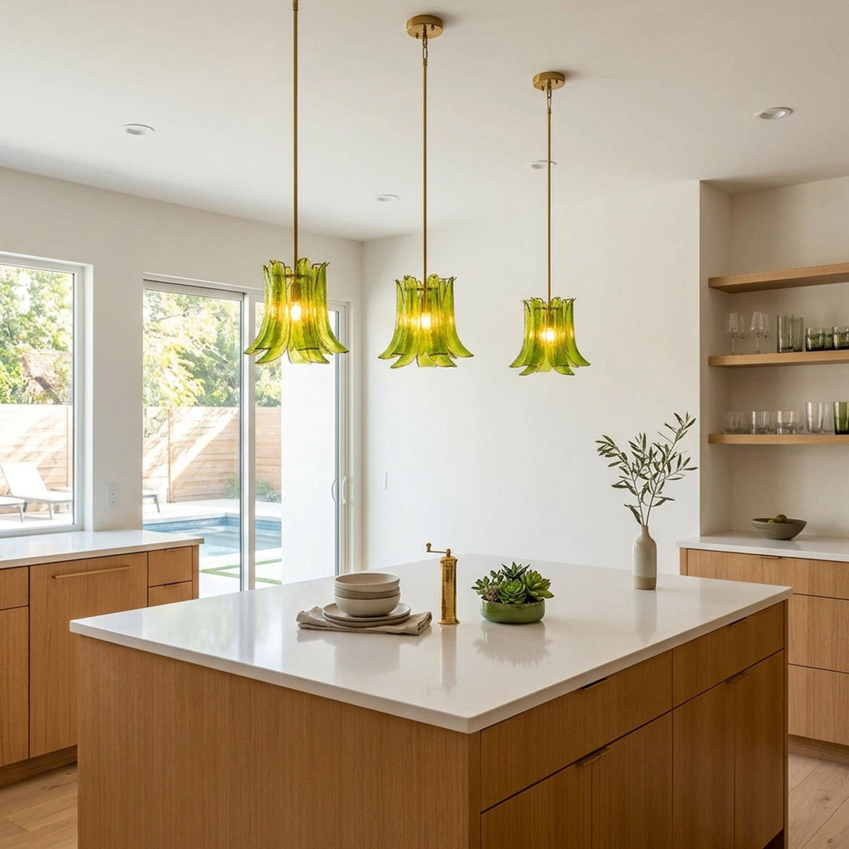 Semoy Curved Glass Petal Pendant Light | Curved Glass and Brass | Trio of green pendant lights suspended over a kitchen island counter | Severn Lighting