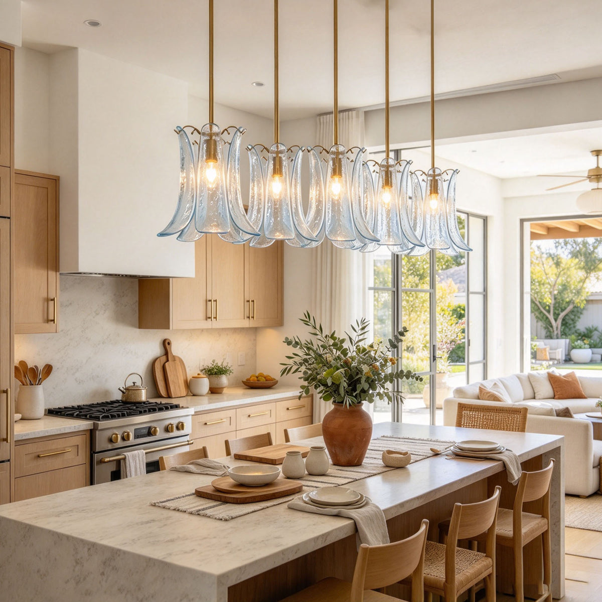 Semoy Curved Glass Petal Pendant Light | Curved Glass and Brass | Row of clear glass pendant lights hanging over a dining table in a bright room | Severn Lighting