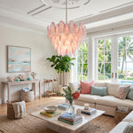 Seraphina Rose Glass Petal Chandelier | Glass, Metal | Casting a cozy romantic ambiance over a cream fabric sectional sofa and low coffee table in a sunlit coastal living room | Severn Lighting