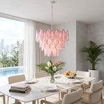 Seraphina Rose Glass Petal Chandelier | Glass, Metal | Suspended as a striking centerpiece over a modern white dining table in a luxurious villa dining room overlooking a swimming pool | Severn Lighting