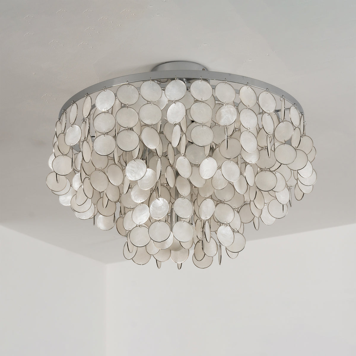 Sirena Capiz Disc Tiered Ceiling Light | Shell, Metal | Low-angle view of the unlit white capiz shell ceiling light mounted on a plain white ceiling | Samu Lamp