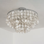 Sirena Capiz Disc Tiered Ceiling Light | Shell, Metal | Low-angle view of the unlit white capiz shell ceiling light mounted on a plain white ceiling | Samu Lamp