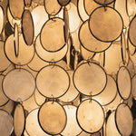 Sirena Capiz Disc Tiered Ceiling Light | Shell, Metal | Macro focus on the translucent circular capiz shells glowing with warm yellow backlighting | Detail shot | Samu Lamp