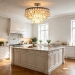 Sirena Capiz Disc Tiered Ceiling Light | Shell, Metal | Mounted as central ceiling illumination above a large white island in a contemporary classic kitchen | Samu Lamp