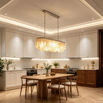 Sirena Capiz Elongated Linear Chandelier | Capiz Shell, Metal | Linear island lighting providing a bright, inviting atmosphere in a contemporary wood and white kitchen | Samu Lamp