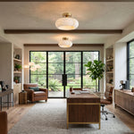 Solaine Alabaster Dome Ceiling Light | Natural Alabaster and Brass | Warm ceiling lighting in a cozy study with glass patio doors | Severn Lighting