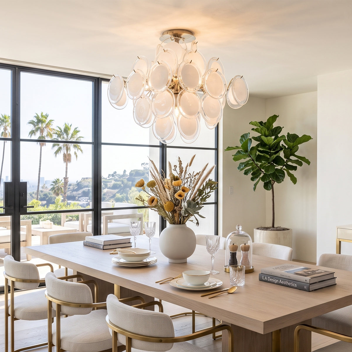 Solene Clustered Glass Disc Ceiling Light | Clear and Frosted Glass Discs | Hanging above a modern wooden dining table in a room with a palm tree window view | Severn Lighting