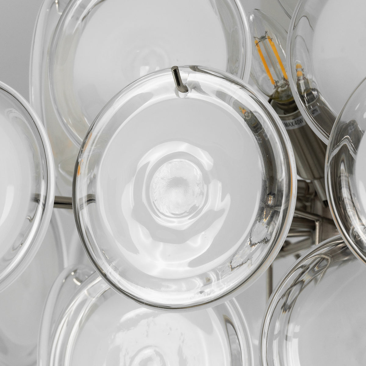 Solene Clustered Glass Disc Ceiling Light | Clear and Frosted Glass Discs | Placed in a sun-drenched dining area with glass doors opening to a backyard swimming pool | Severn Lighting