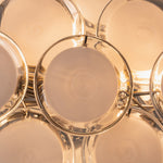 Solene Clustered Glass Disc Ceiling Light | Clear and Frosted Glass Discs | Close-up macro view highlighting the warm golden light source filtering through the round glass plates | Severn Lighting