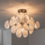 Solene Clustered Glass Disc Ceiling Light | Clear and Frosted Glass Discs | Looking up perspective of the fully illuminated flush mount fixture near a room corner wall | Severn Lighting